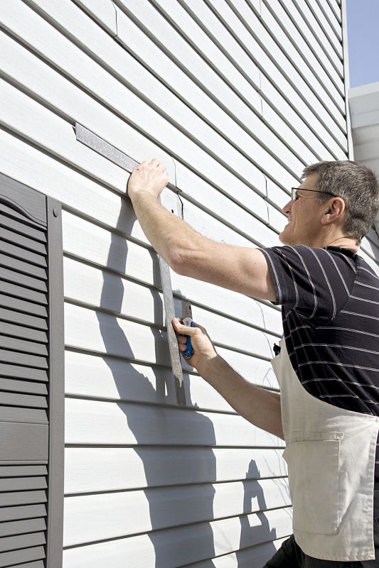 Siding contractor measuring panels